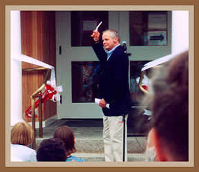 Charles Morrill cuts the ribbon at the dedication of the new addition in 2000.